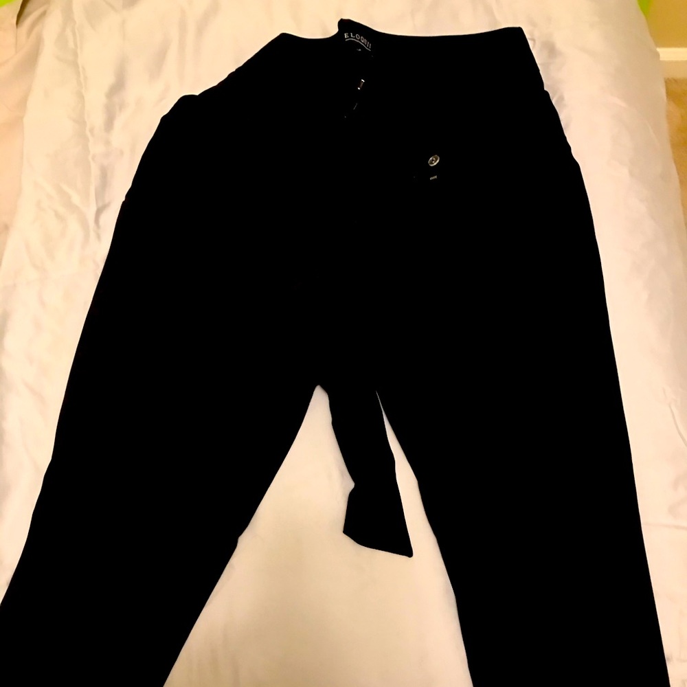 Black ankle length paper bag waist slacks.